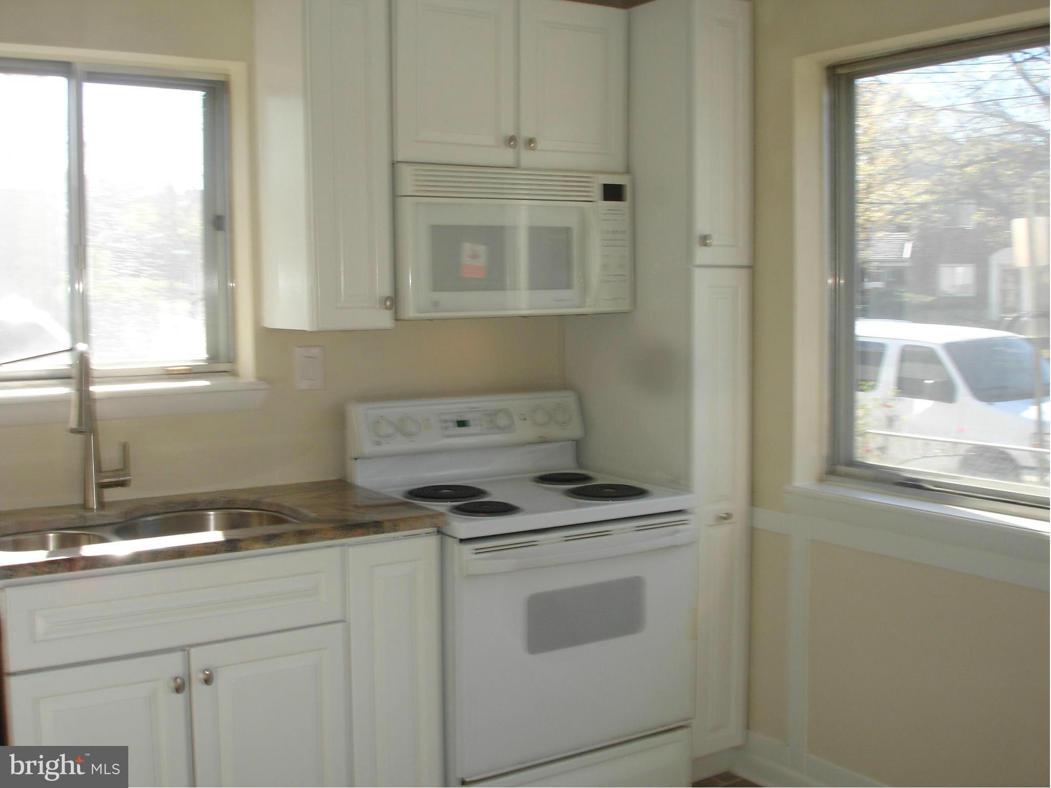 4705 Sargent Road Northeast Washington, DC 20017 - Photo 4 of 24 a kitchen with granite countertop white cabinets and a stove