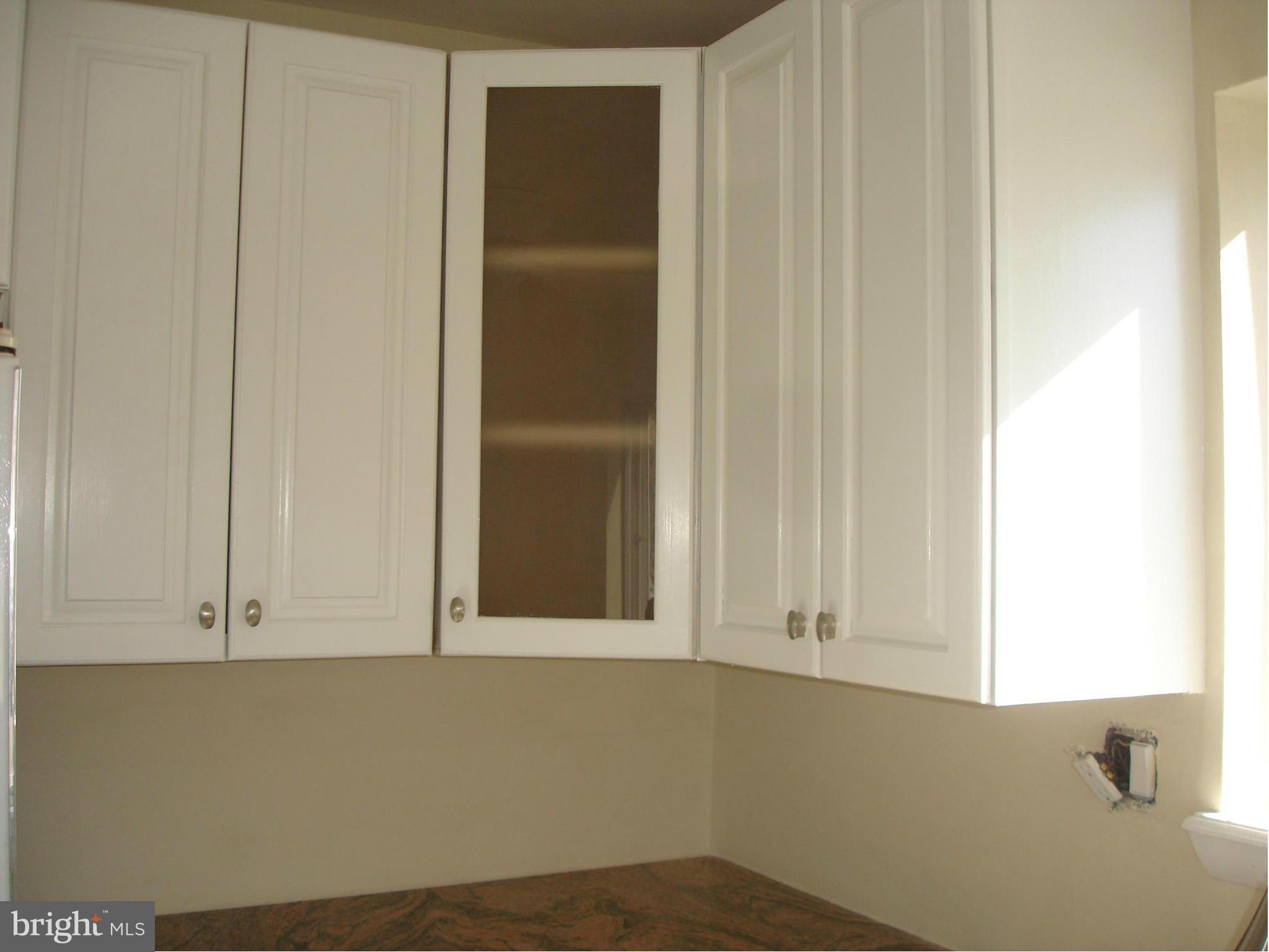 4705 Sargent Road Northeast Washington, DC 20017 - Photo 6 of 24 a view of an empty room with cabinet and a window
