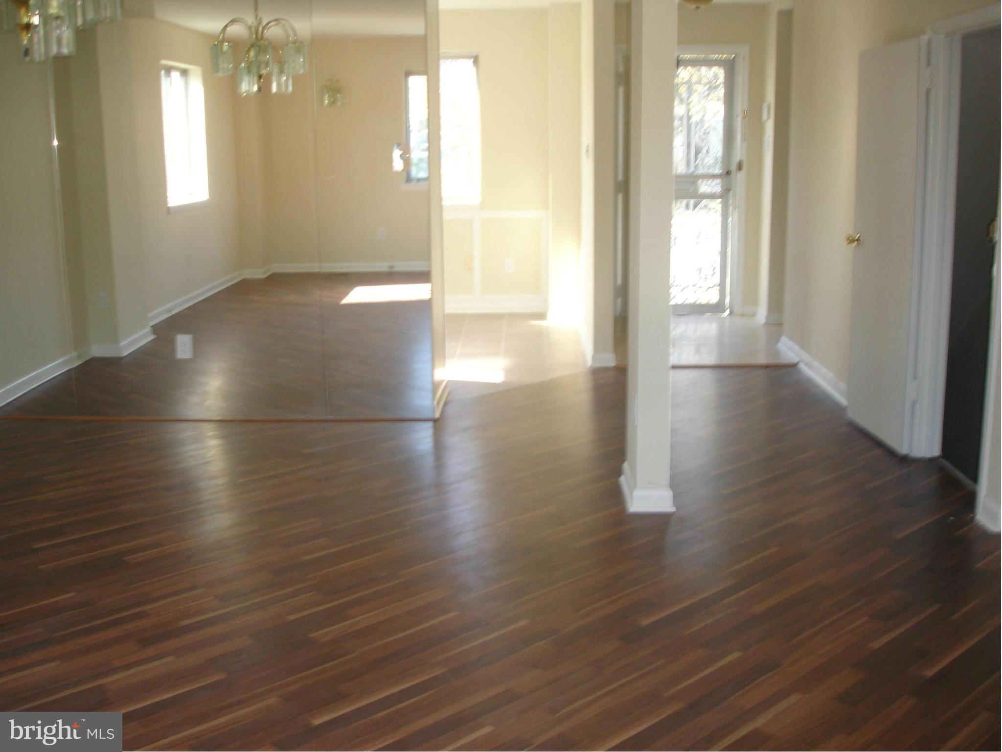 4705 Sargent Road Northeast Washington, DC 20017 - Photo 8 of 24 an empty room with wooden floor and windows