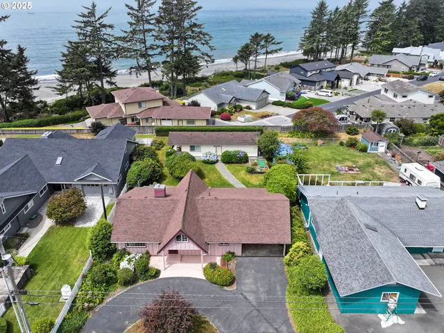 an aerial view of residential houses with outdoor space and swimming pool