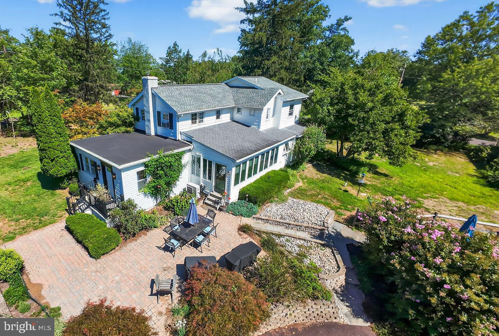 an aerial view of a house with a yard basket ball court and outdoor seating