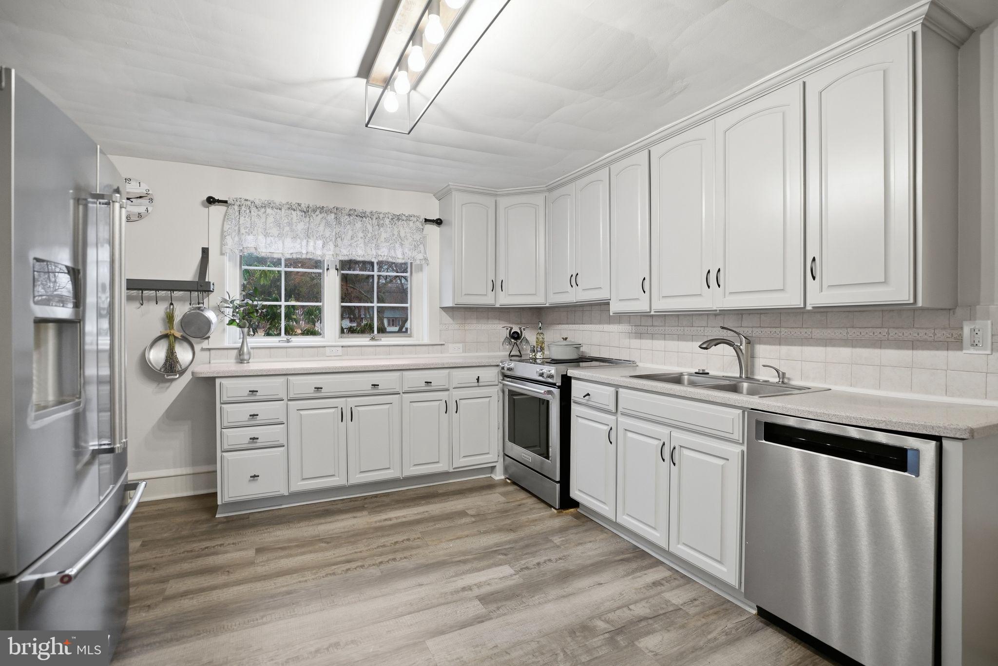 330 Fairhill Road Hatfield, PA 19440 - Photo 12 of 49 a kitchen with granite countertop white cabinets and white appliances