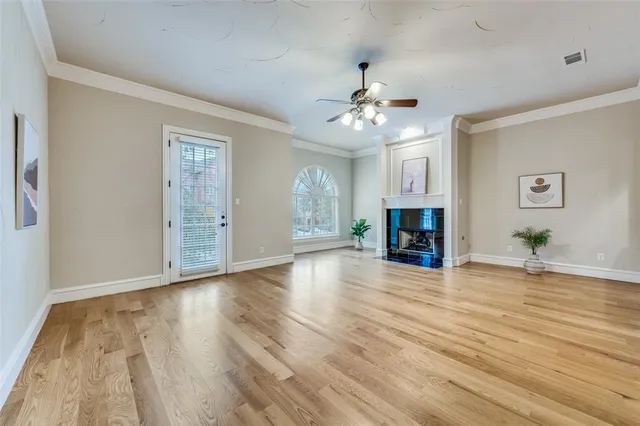 a view of a livingroom with wooden floor and a ceiling fan