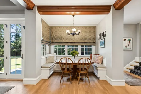 a view of staircase with lots of frames on wall and wooden floor