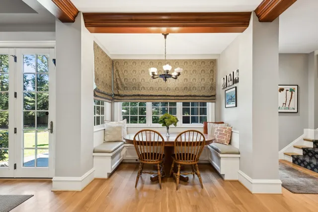 a view of staircase with lots of frames on wall and wooden floor