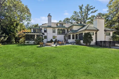 a view of a patio with table and chairs and wooden fence