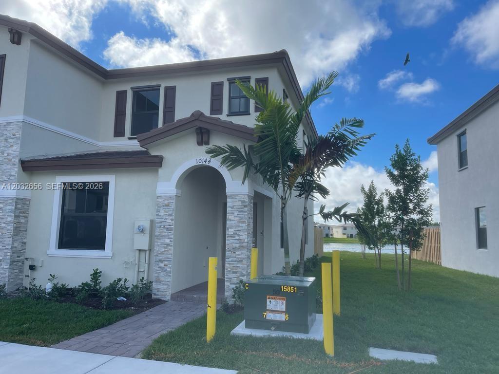10144 Southwest 228th Terrace Miami, FL 33190 - Photo 3 of 23 a front view of a house with garden