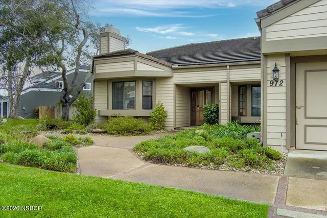 front view of a brick house with a yard
