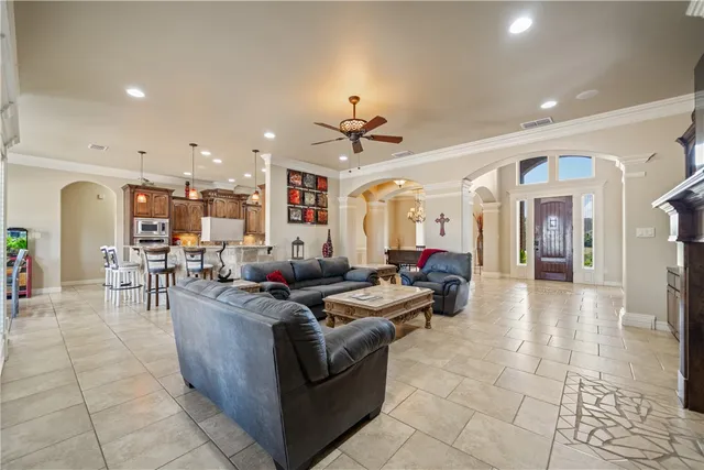 a living room with furniture a fireplace and a flat screen tv