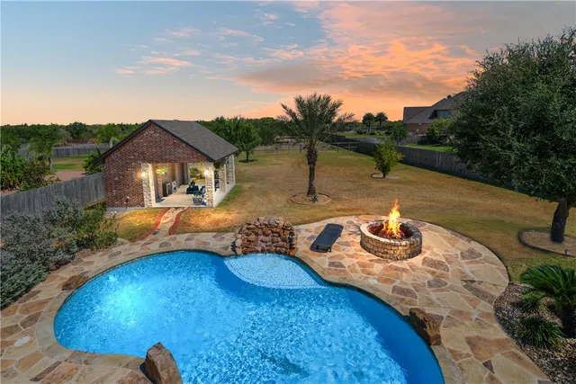a view of a swimming pool with a patio