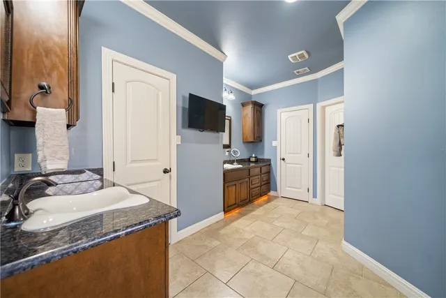 a large bathroom with a granite countertop double vanity sink a mirror a bathtub and shower