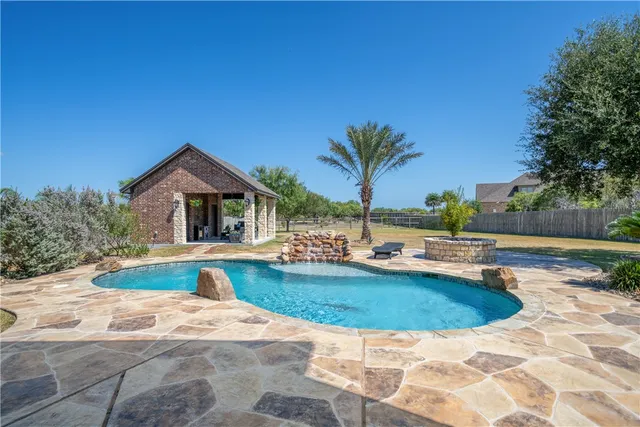 a view of a house with backyard and deck