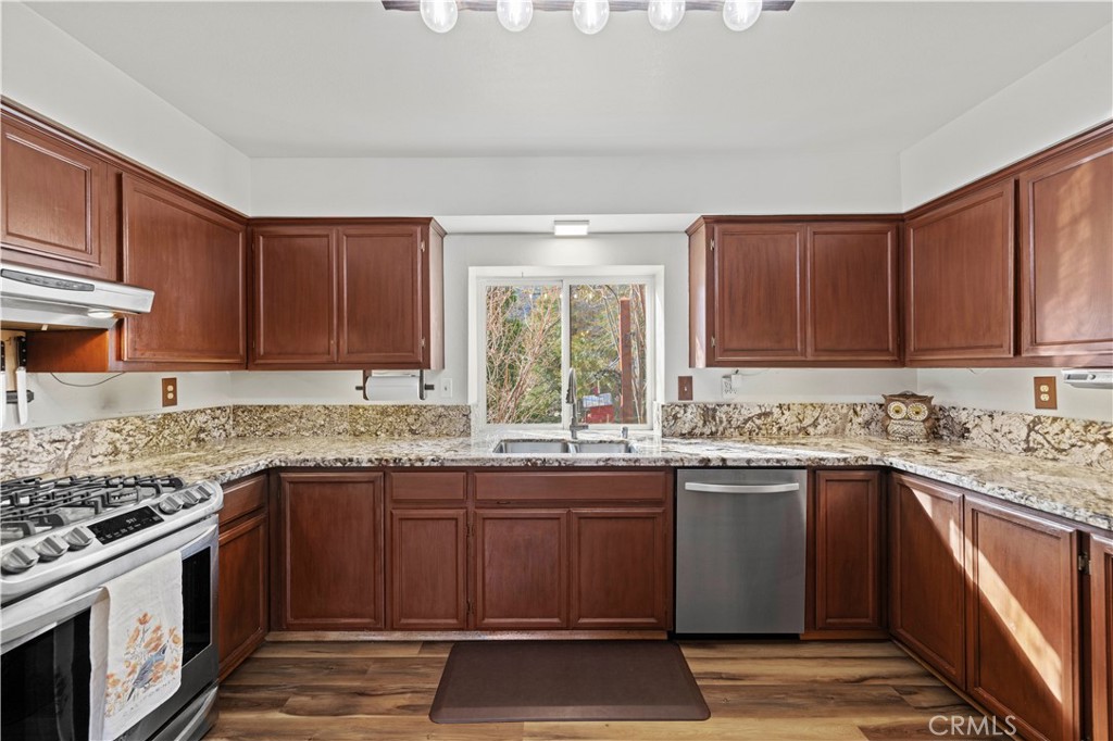 921 Piru Way Frazier Park, CA 93225 - Photo 12 of 62 a kitchen with stainless steel appliances granite countertop a sink stove and cabinets