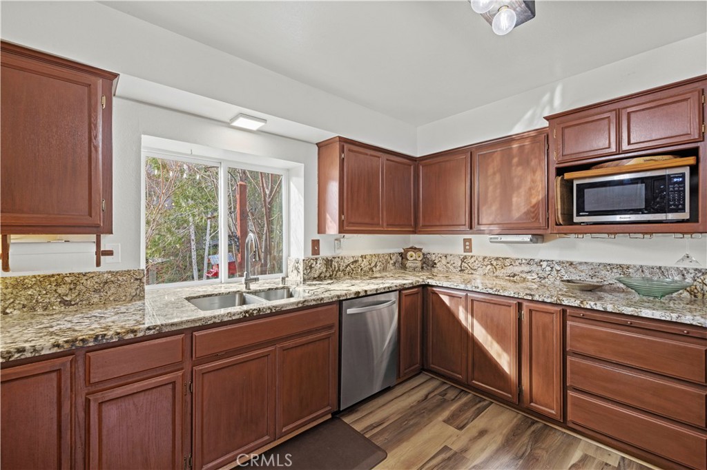 921 Piru Way Frazier Park, CA 93225 - Photo 13 of 62 a kitchen with granite countertop cabinets sink and window