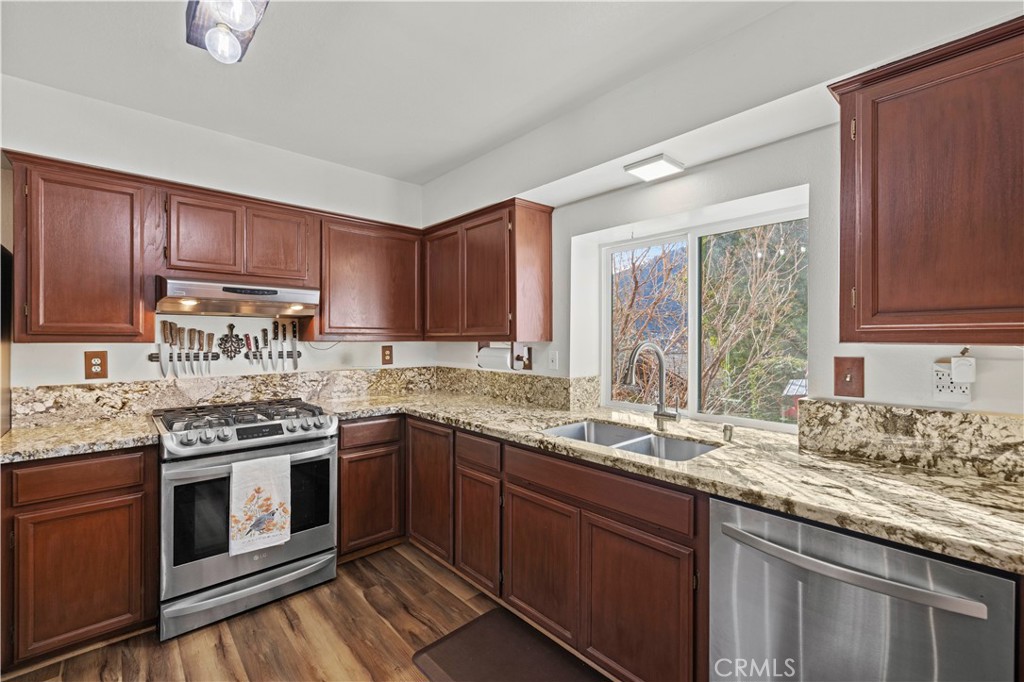 921 Piru Way Frazier Park, CA 93225 - Photo 14 of 62 a kitchen with stainless steel appliances granite countertop a sink stove and cabinets