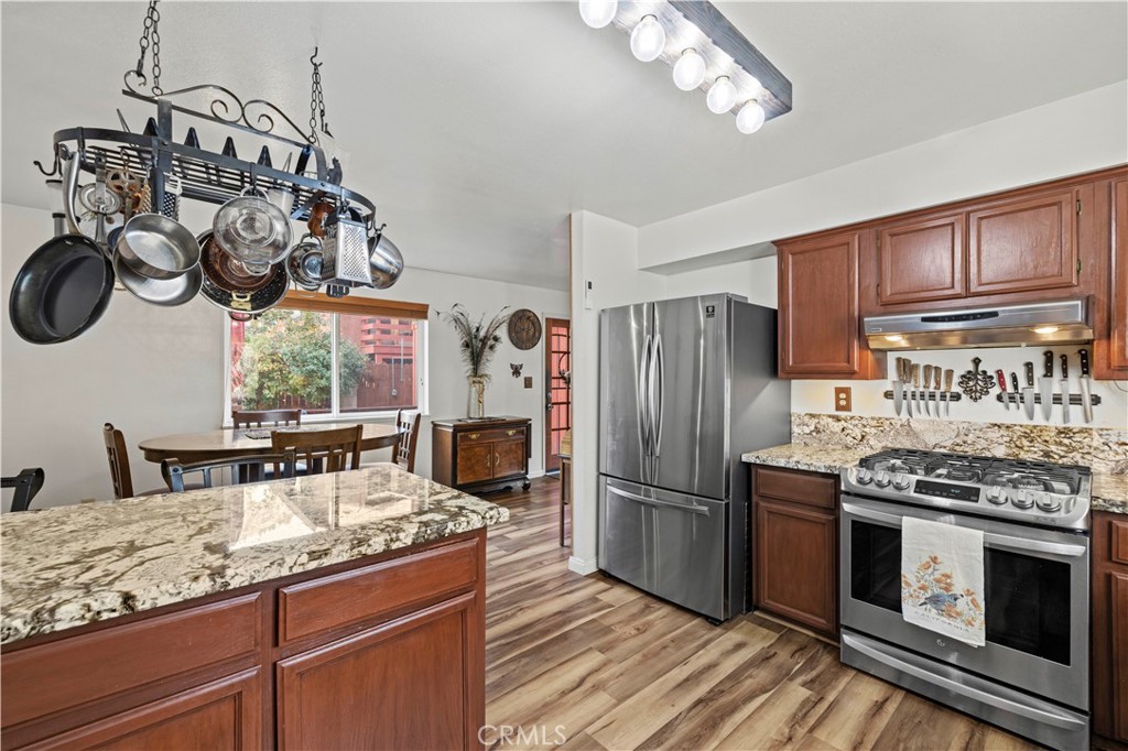 921 Piru Way Frazier Park, CA 93225 - Photo 16 of 62 a kitchen with stainless steel appliances granite countertop a sink a stove a refrigerator and cabinets