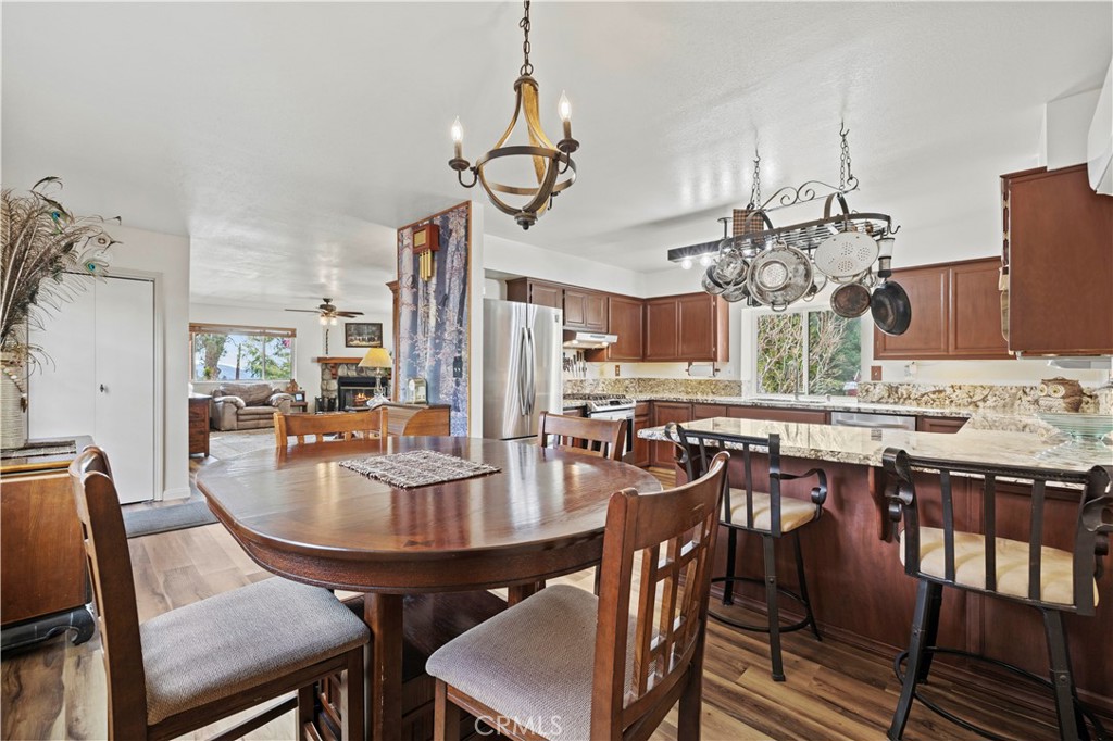 921 Piru Way Frazier Park, CA 93225 - Photo 19 of 62 a view of a dining room with furniture a chandelier and wooden floor