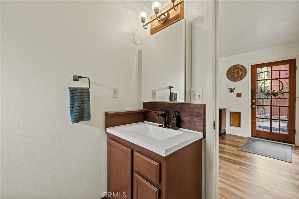 921 Piru Way Frazier Park, CA 93225 - Photo 21 of 62 a bathroom with a sink a mirror and a window