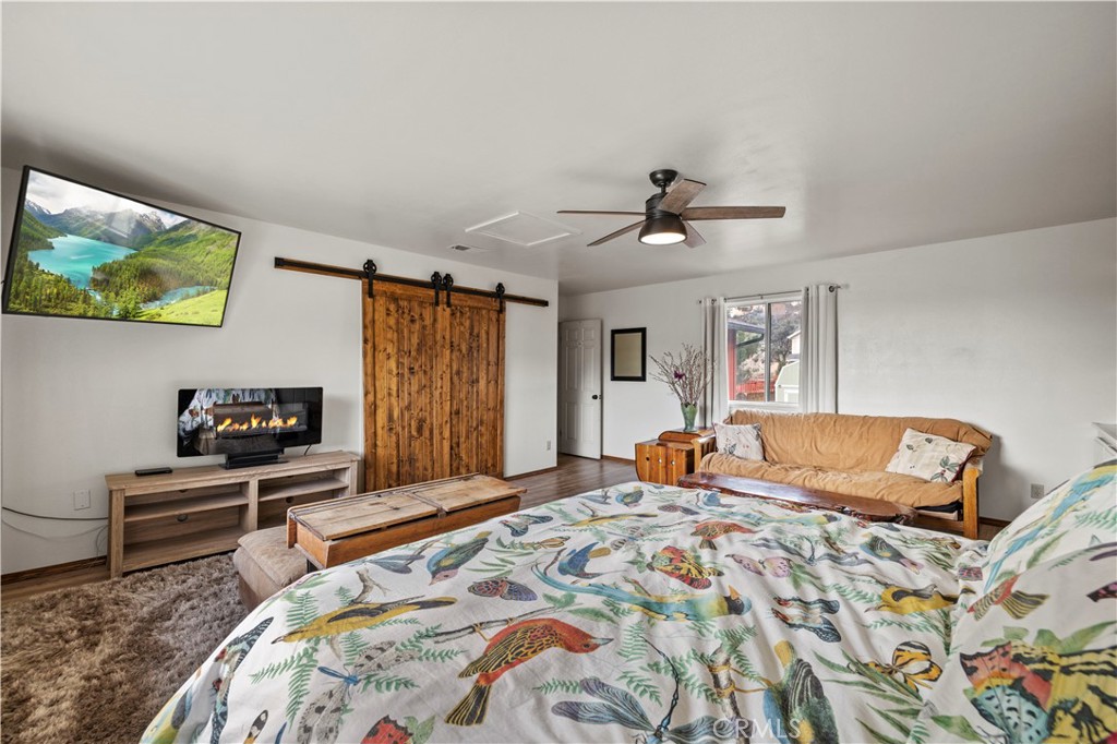 921 Piru Way Frazier Park, CA 93225 - Photo 24 of 62 a bedroom with a bed and a flat screen tv