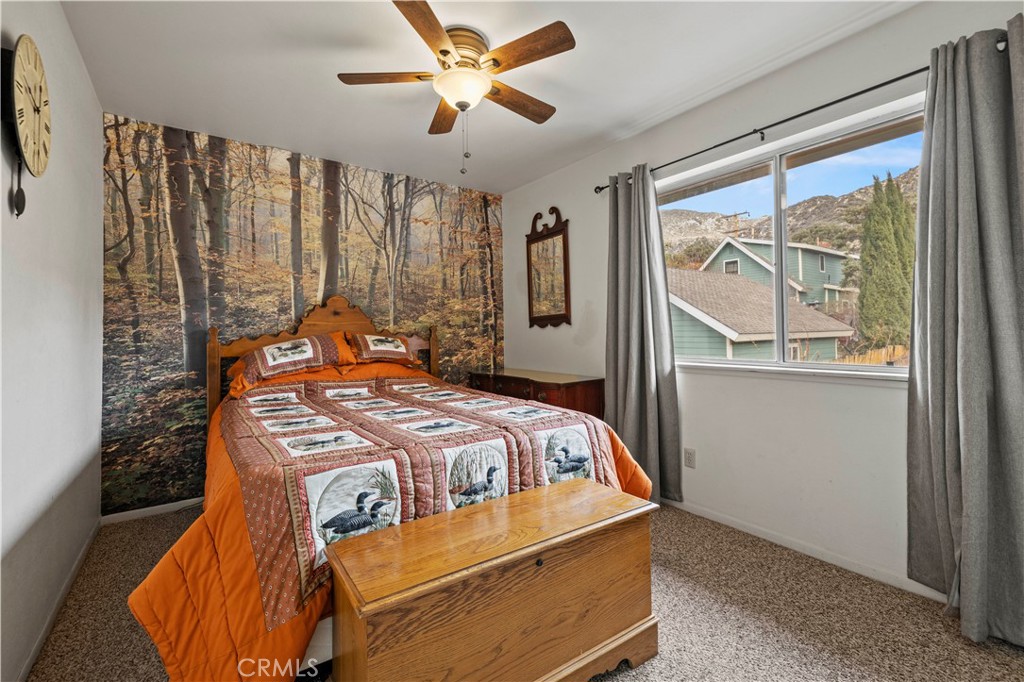 921 Piru Way Frazier Park, CA 93225 - Photo 26 of 62 a bedroom with a large bed and a chandelier