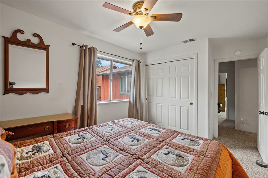 921 Piru Way Frazier Park, CA 93225 - Photo 27 of 62 a bedroom with a bed and a chandelier