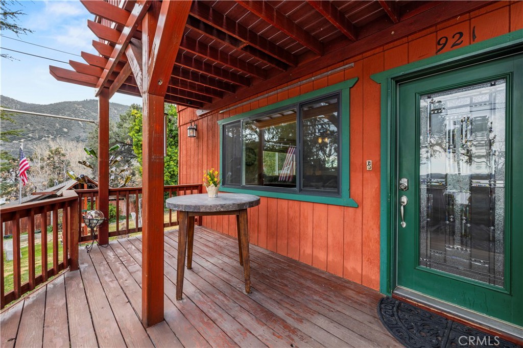 921 Piru Way Frazier Park, CA 93225 - Photo 5 of 62 a porch area with wooden floor table and outdoor seating