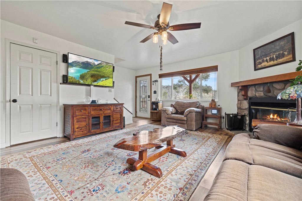 921 Piru Way Frazier Park, CA 93225 - Photo 8 of 62 a living room with furniture a flat screen tv and a fireplace