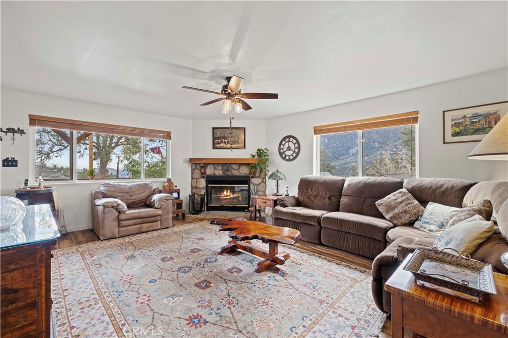 921 Piru Way Frazier Park, CA 93225 - Photo 9 of 62 a living room with furniture a large window and a fireplace