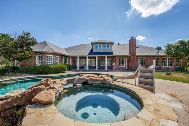 a swimming pool with outdoor seating and yard
