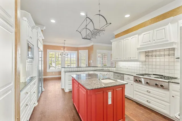 a kitchen with stainless steel appliances granite countertop a stove and a sink