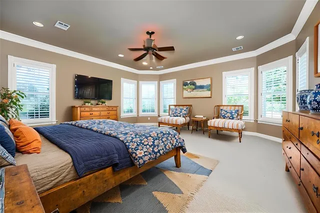 a bedroom with a bed couch and a flat screen tv