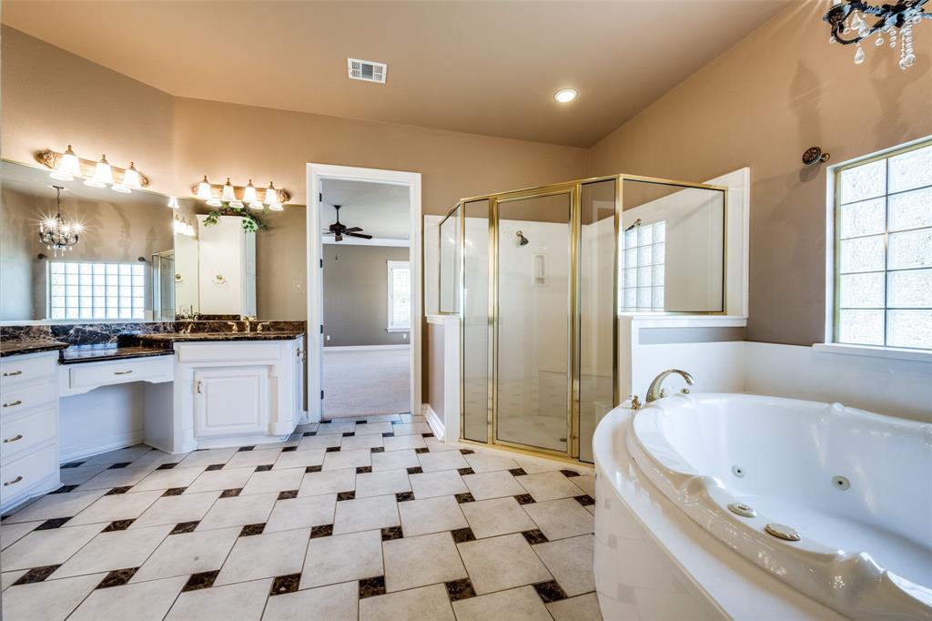 2080 County Road 2445 Decatur, TX 76234 - Photo 15 of 40 a bathroom with a bathtub sink and a shower