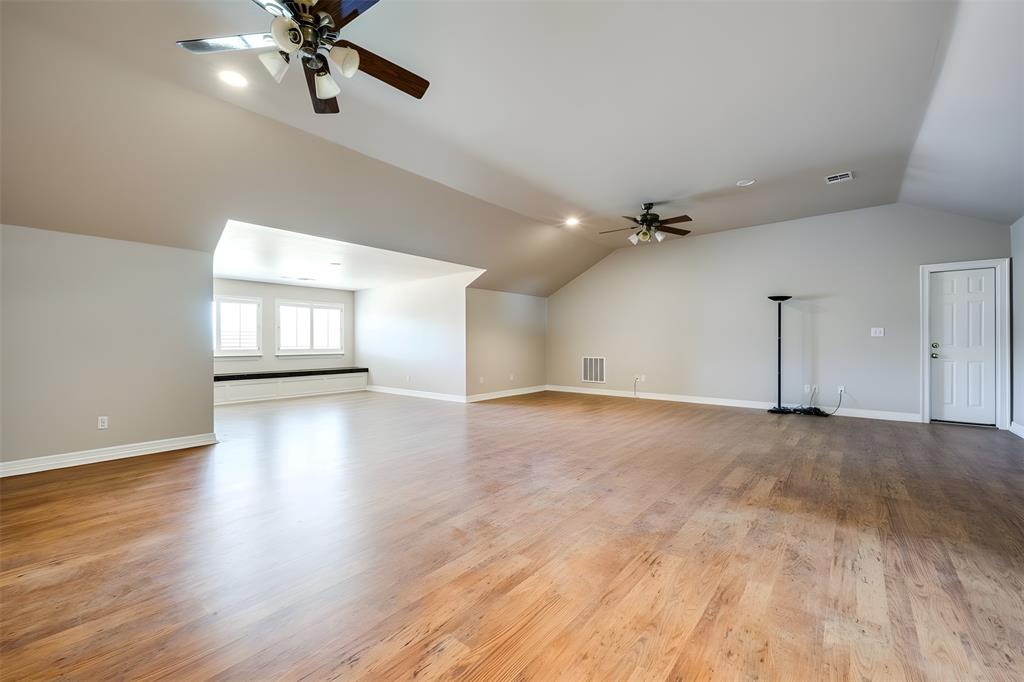 2080 County Road 2445 Decatur, TX 76234 - Photo 18 of 40 a view of an empty room with a window and wooden floor