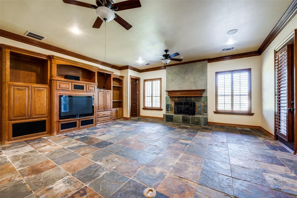 2080 County Road 2445 Decatur, TX 76234 - Photo 31 of 40 a view of an empty room with a fireplace and a window