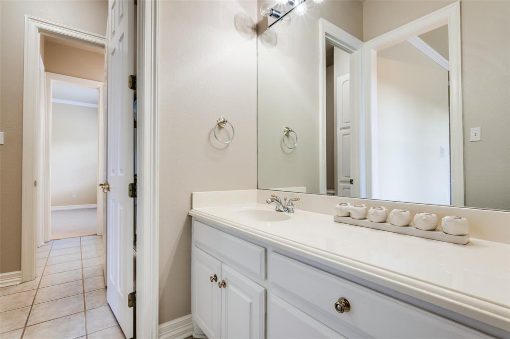 2080 County Road 2445 Decatur, TX 76234 - Photo 34 of 40 a bathroom with a double vanity sink and mirror