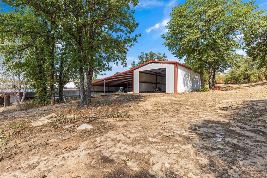 2080 County Road 2445 Decatur, TX 76234 - Photo 37 of 40 a front view of a house with a yard and large trees