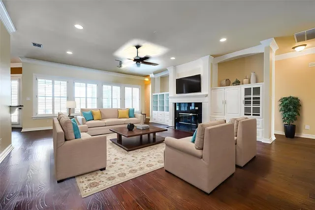 a living room with fireplace furniture and a wooden floor