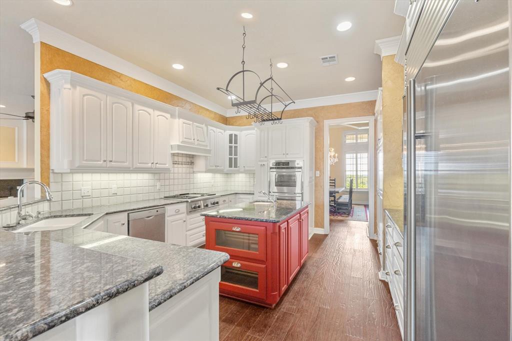2080 County Road 2445 Decatur, TX 76234 - Photo 8 of 40 a kitchen with stainless steel appliances granite countertop a sink a stove and a refrigerator