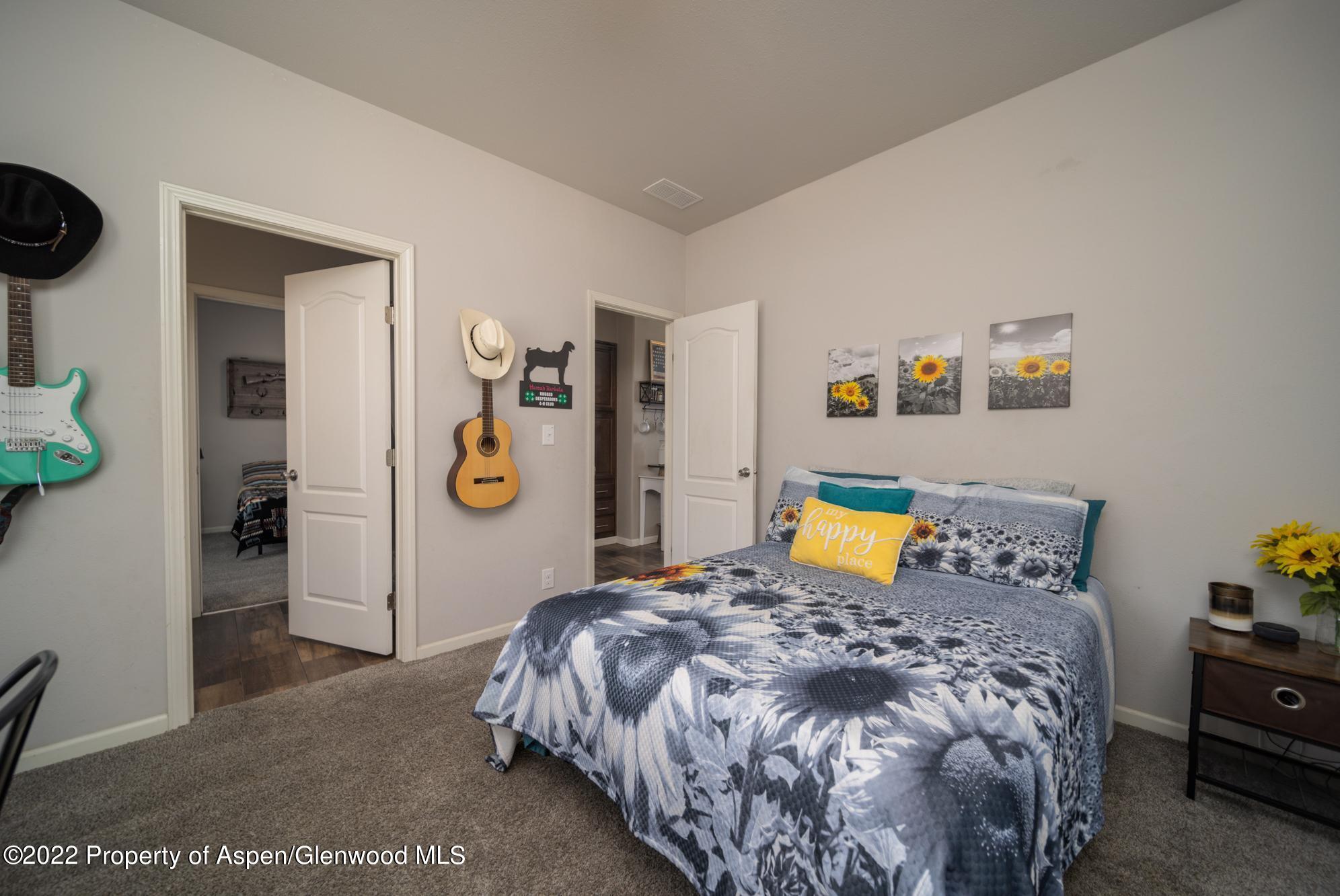 308 Cindys Way Rifle, CO 81650 - Photo 23 of 29 a bed sitting in a bedroom next to a window