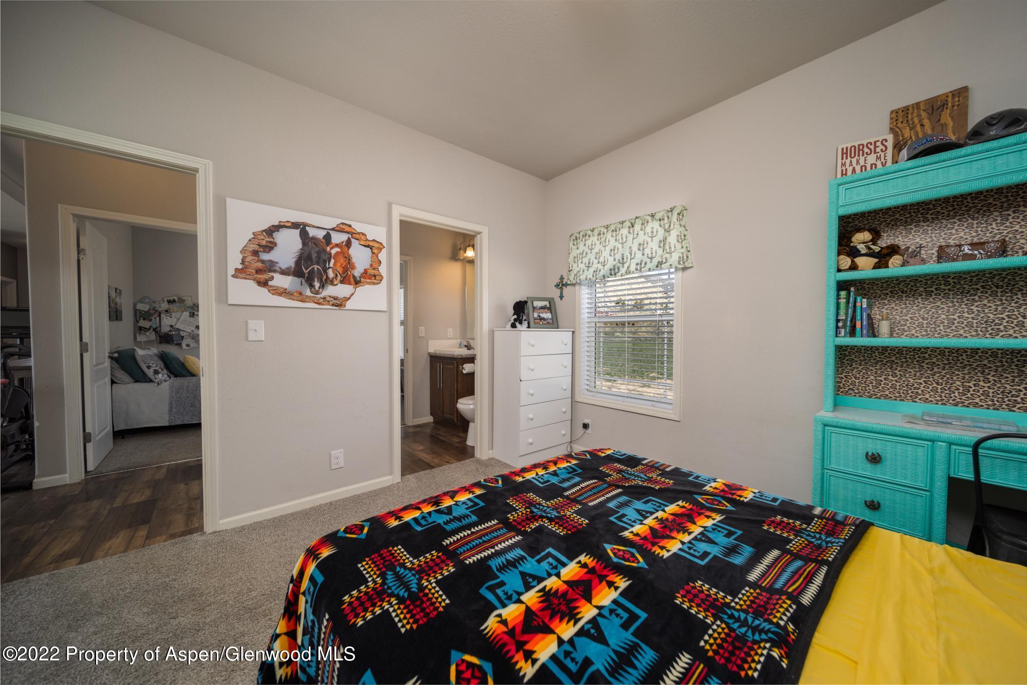 308 Cindys Way Rifle, CO 81650 - Photo 26 of 29 a bedroom with a bed and a window in it