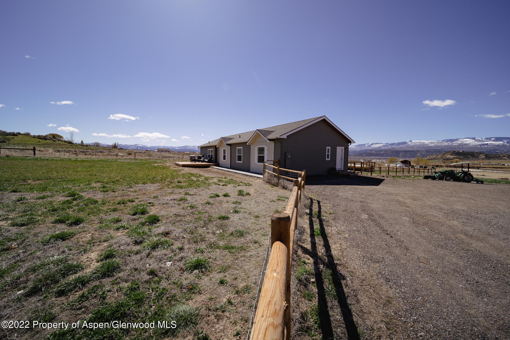 308 Cindys Way Rifle, CO 81650 - Photo 5 of 29 a view of a yard in front of a house with a yard