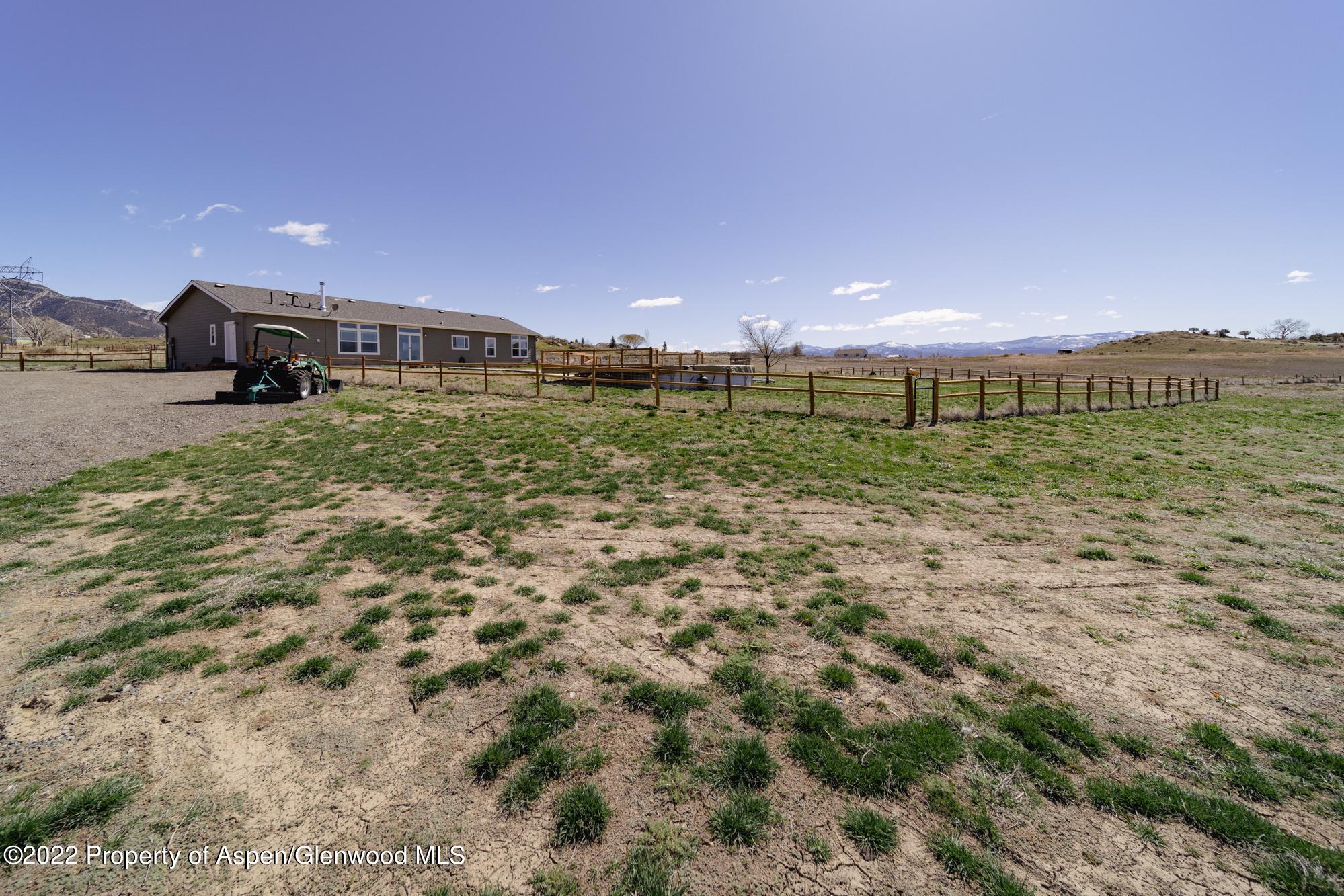 308 Cindys Way Rifle, CO 81650 - Photo 6 of 29 a view of a back yard of the house with a street