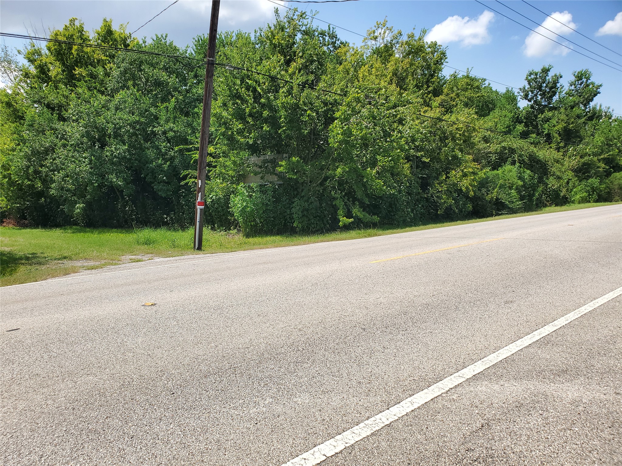 1635 West Cedar Bayou Lynchburg Road Baytown, TX 77521 - Photo 15 of 18 a view of a field with trees in the background