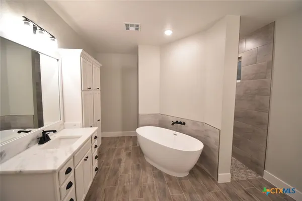 a bathroom with a double vanity sink and a mirror
