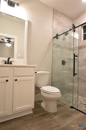 a bathroom with a toilet a sink and shower