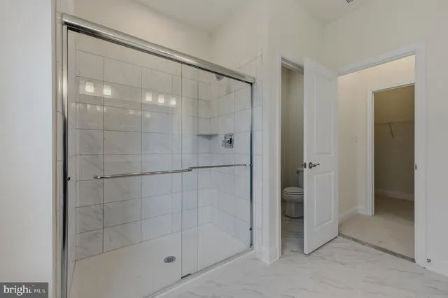a bathroom with a glass shower door