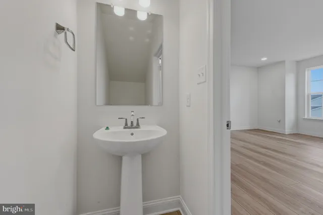 a bathroom with a sink a mirror and shower