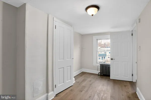 a view of a room with wooden floor cabinets and windows