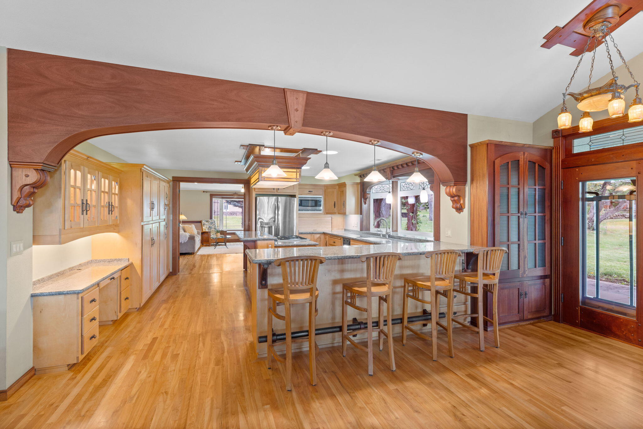 21925 Bear Creek Road Bend, OR 97702 - Photo 26 of 104 Open kitchen w/breakfast bar, workspace, maple kitchen cabinets, solid wood finishes and antique lighting