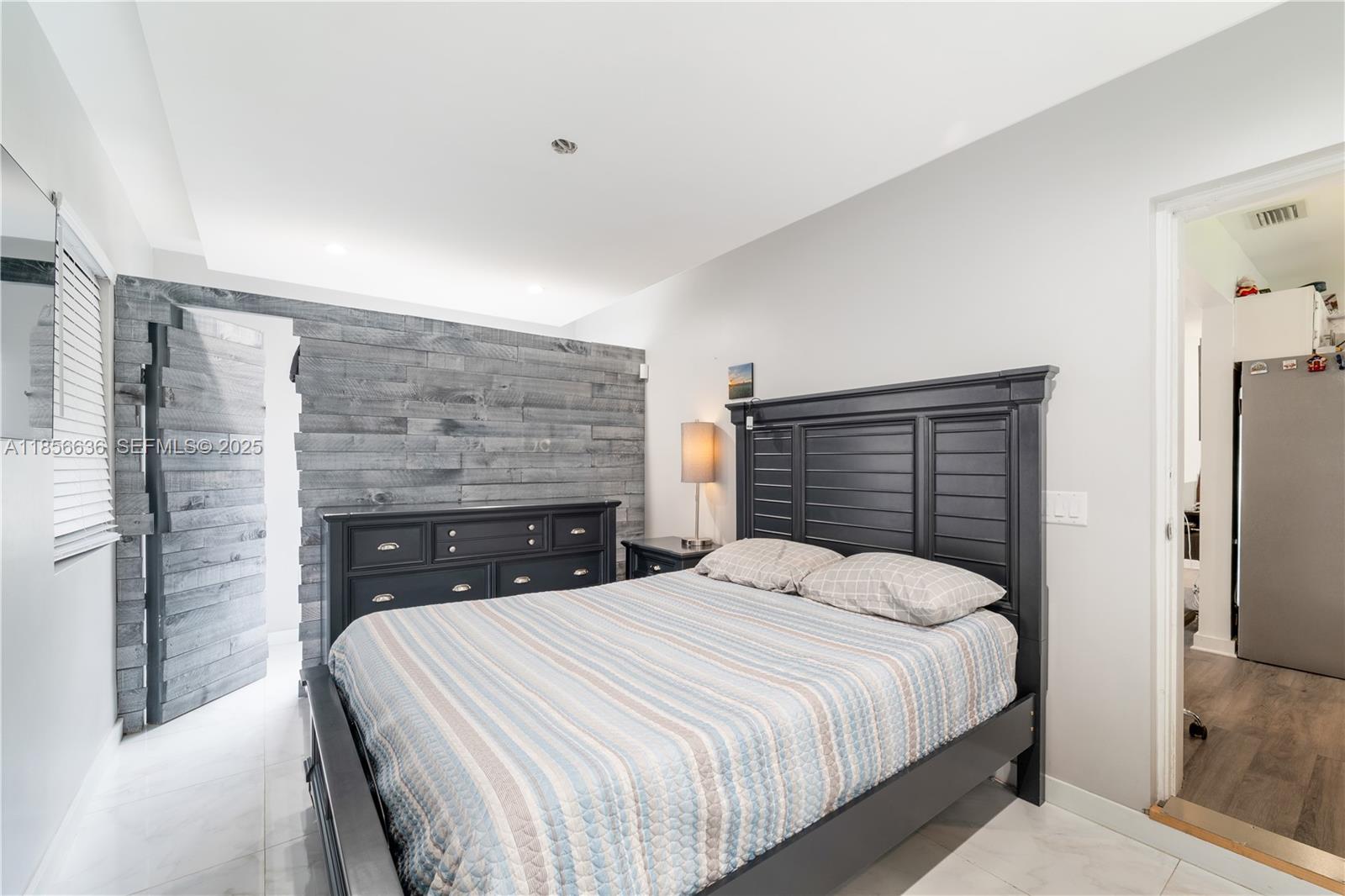 512 Northwest 13th Street Homestead, FL 33030 - Photo 17 of 39 a bedroom with a bed and a fireplace